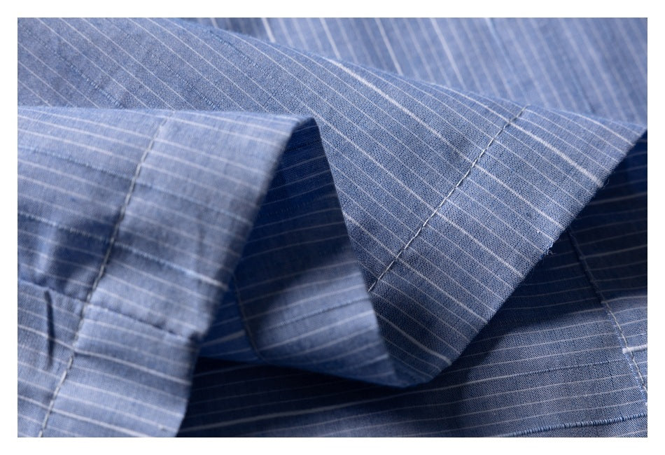 Close-up of the blue shirt's pointed collar and fine white pinstripes.