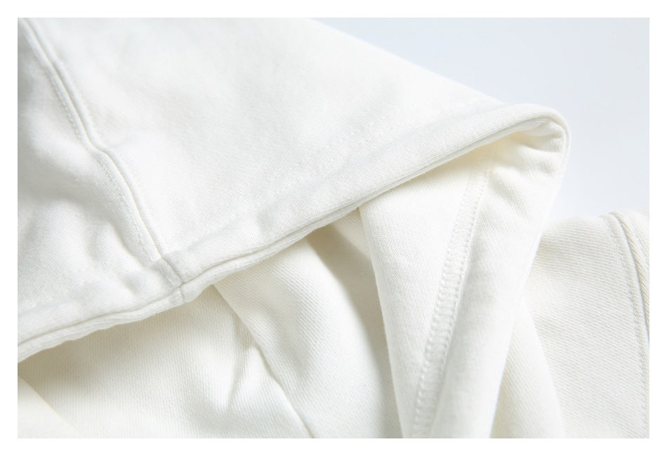 Close-up of the white hoodie’s hood and stitched neckline.