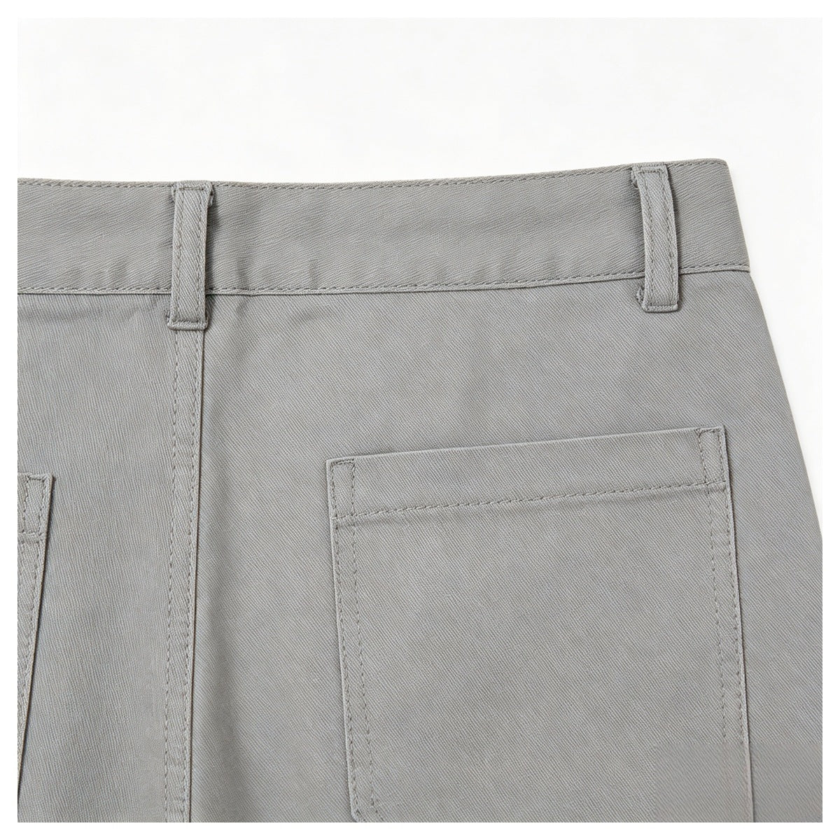 Close-up of the back waist of gray trousers, showing belt loops and a rectangular rear pocket.