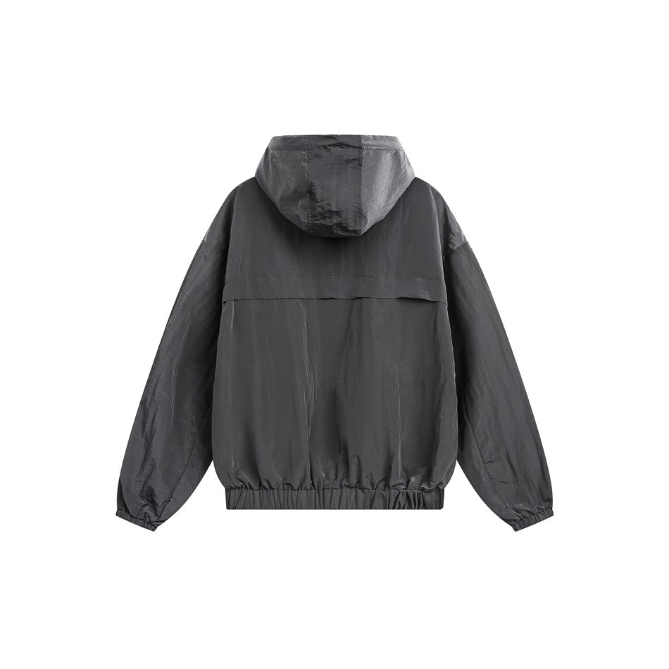 Back view of a dark gray hooded jacket laid flat, with a rear flap and gathered hem and cuffs.