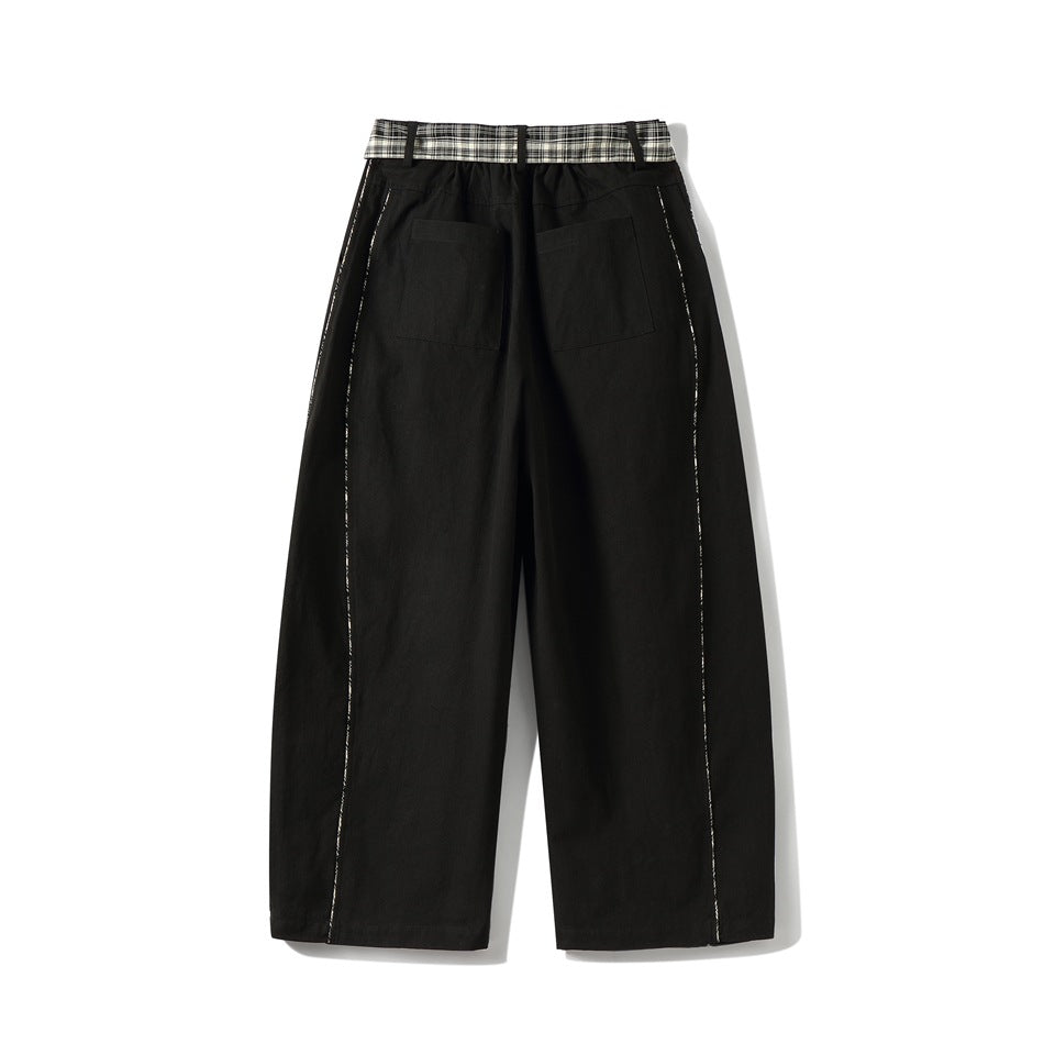 Back view of black wide-leg pants with two patch pockets and plaid waist panel and plaid piping