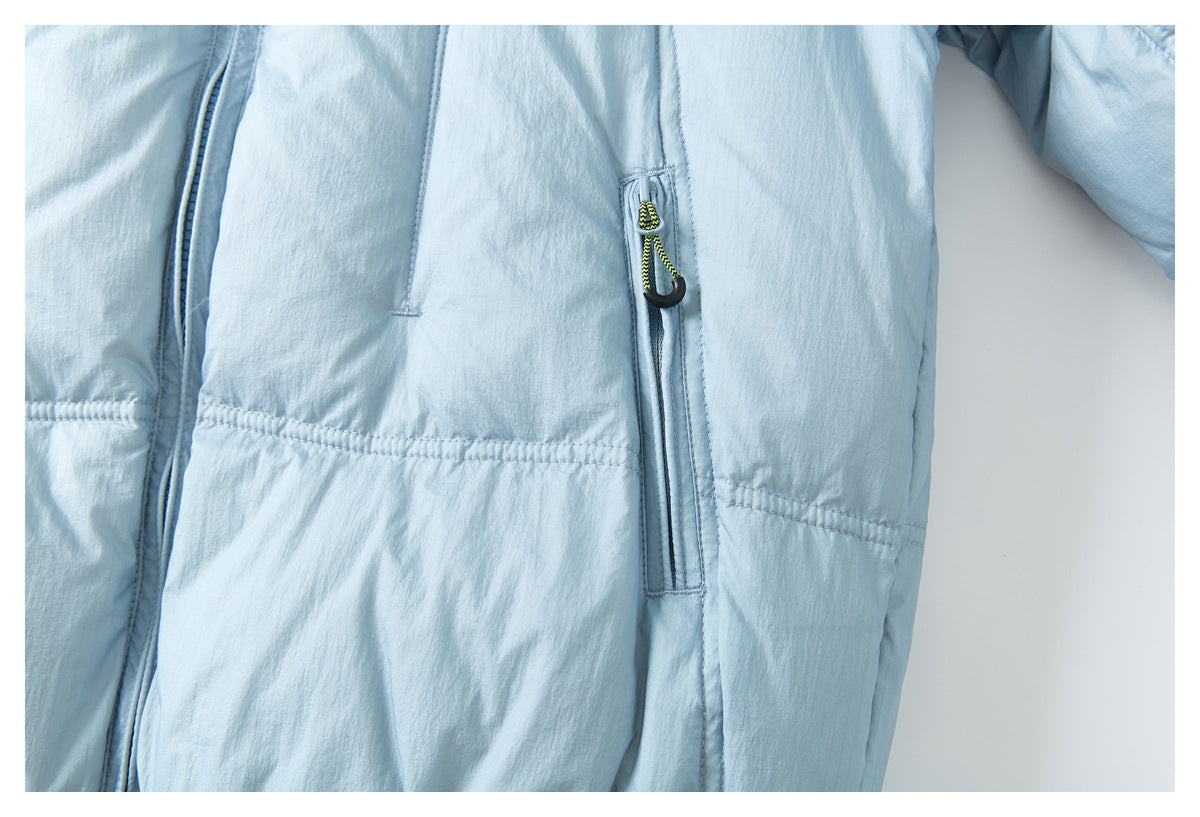 Close-up of a pale blue jacket front with a vertical zip pocket and stitched panel seams.