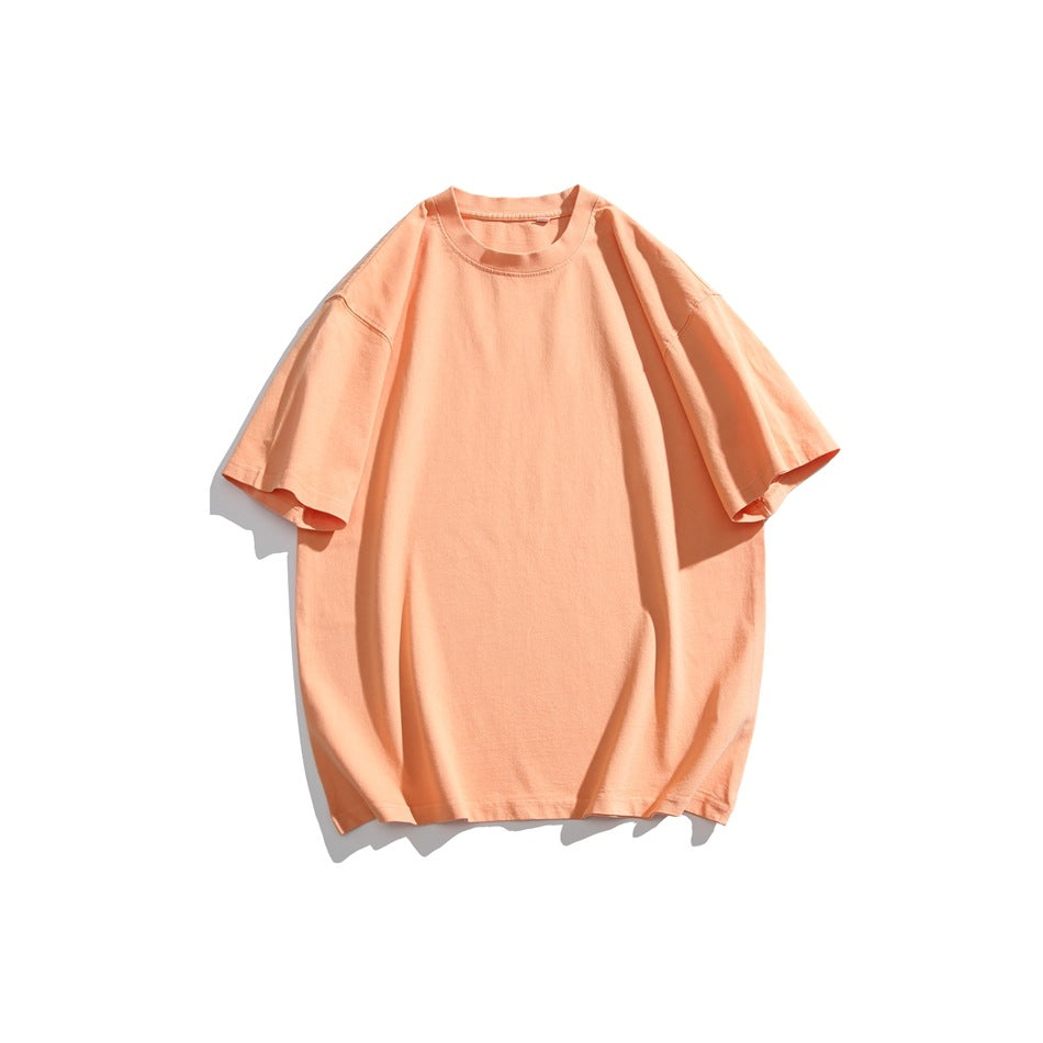 Soft peach short-sleeve crew neck T-shirt with dropped shoulders, flat lay on a white background