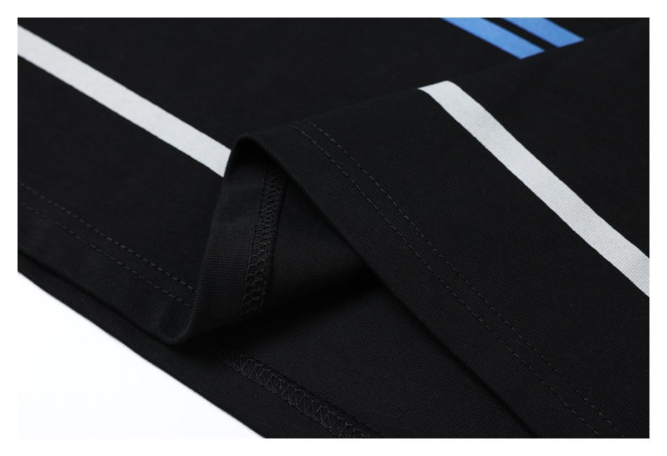 Close-up of black striped fabric folded to show the garment's stitched hem and seam.