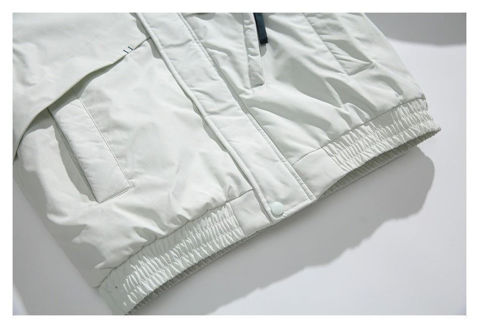 White jacket lower front showing flap pockets, snap placket, and gathered elastic hem.