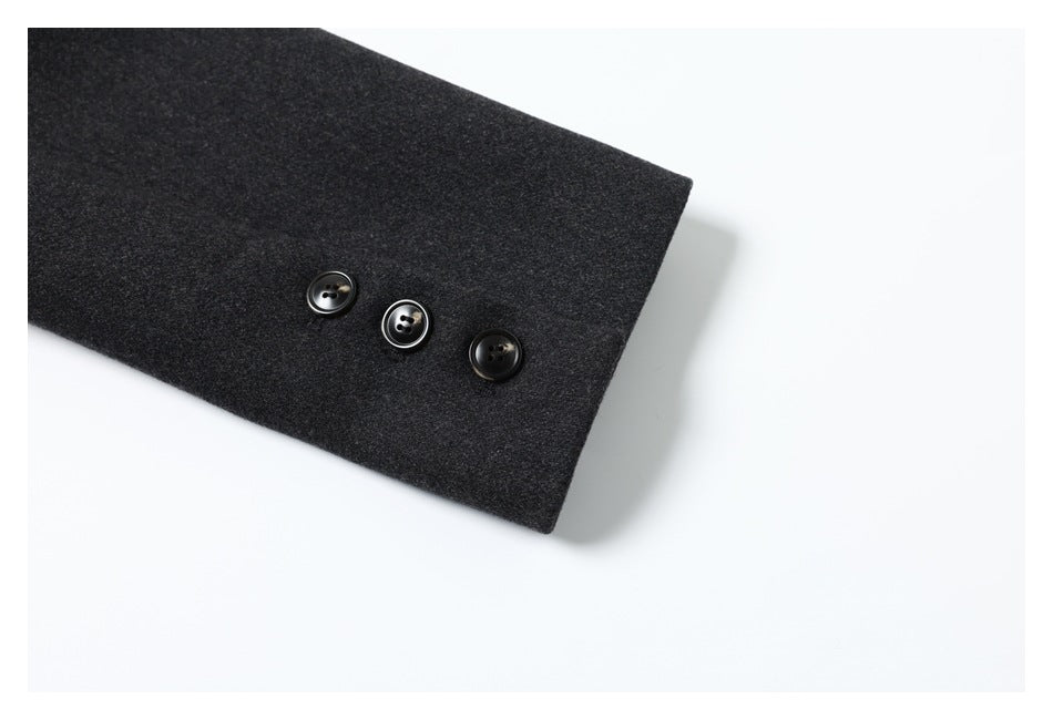 Close-up of a dark charcoal sleeve cuff with three black buttons.
