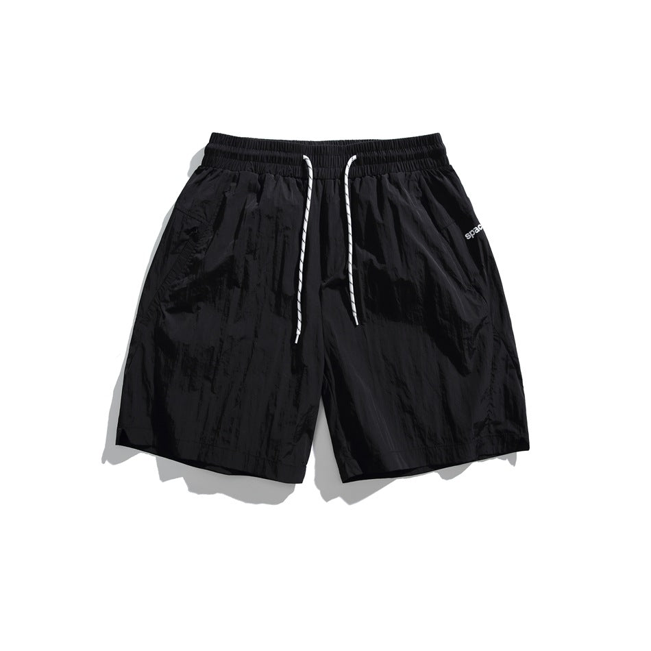 Black drawstring shorts with white cord, flat lay front view
