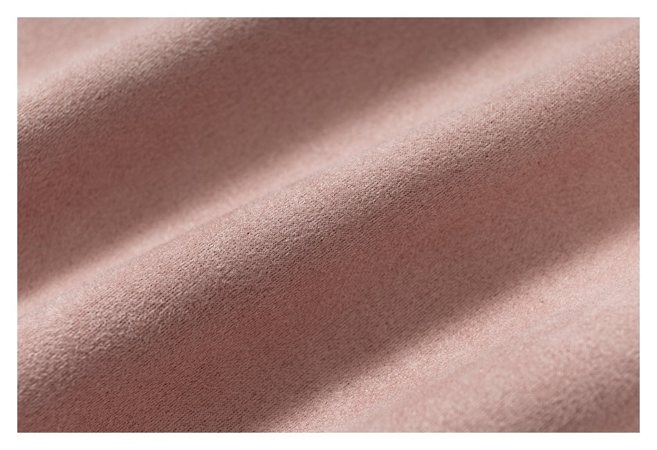 Macro view of the soft-looking surface texture of dusty pink fabric.