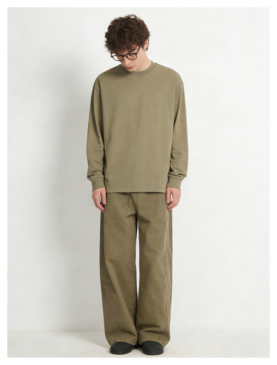 Front view of a model wearing an oversized olive long-sleeve shirt and loose matching trousers.