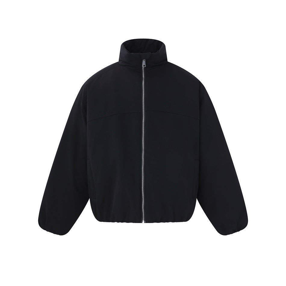 Front view of a black jacket with a high stand collar, silver center zipper, long sleeves and elasticized hem.