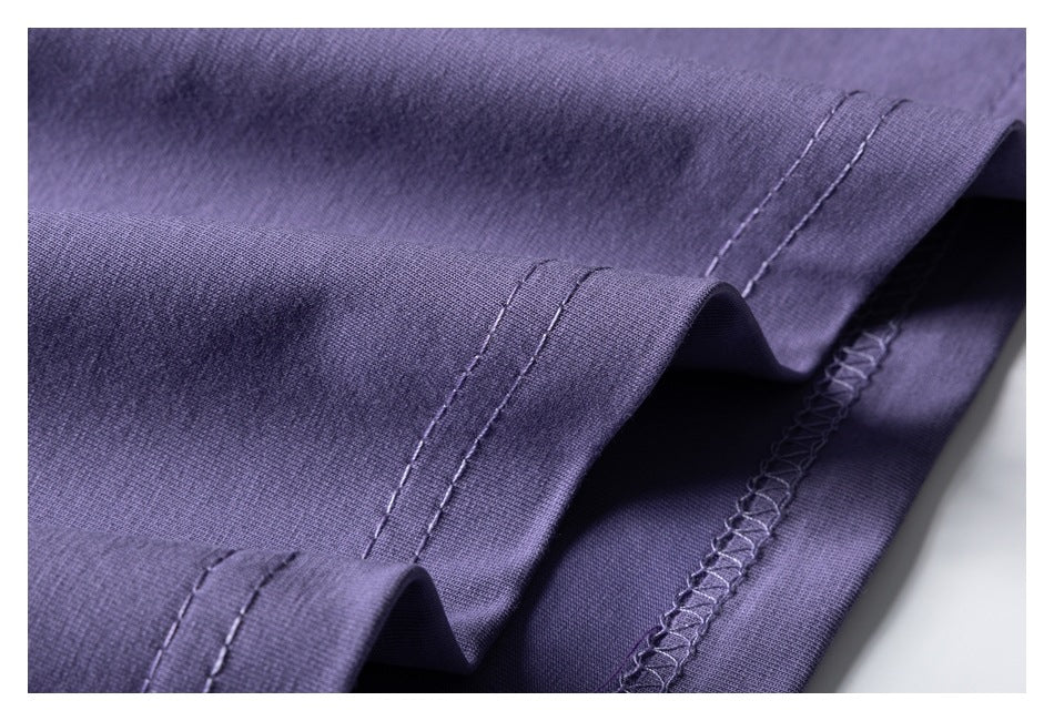 Close-up of the lavender-purple shirt hem with double stitching and an overlocked inner seam.