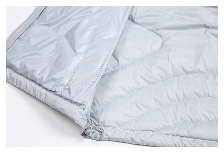 Close-up of the light gray jacket's lower edge with a small toggle and loop fastener.