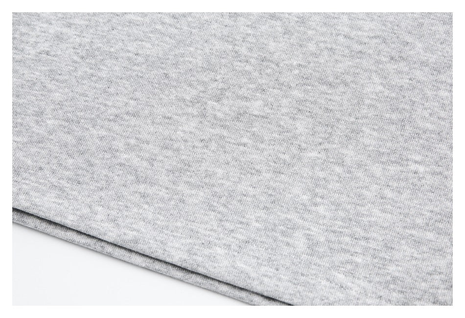 Close-up of the heather gray shirt fabric and folded bottom hem.
