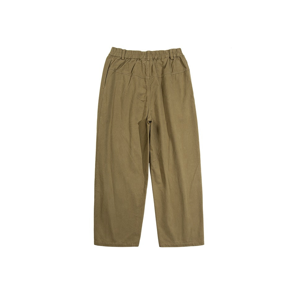Front view of khaki wide-leg pants with an elastic waist, belt loops, and angled pockets on a white background.