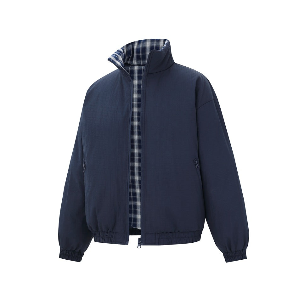 Navy jacket partly unzipped, showing the blue and white plaid reverse side inside the collar and front