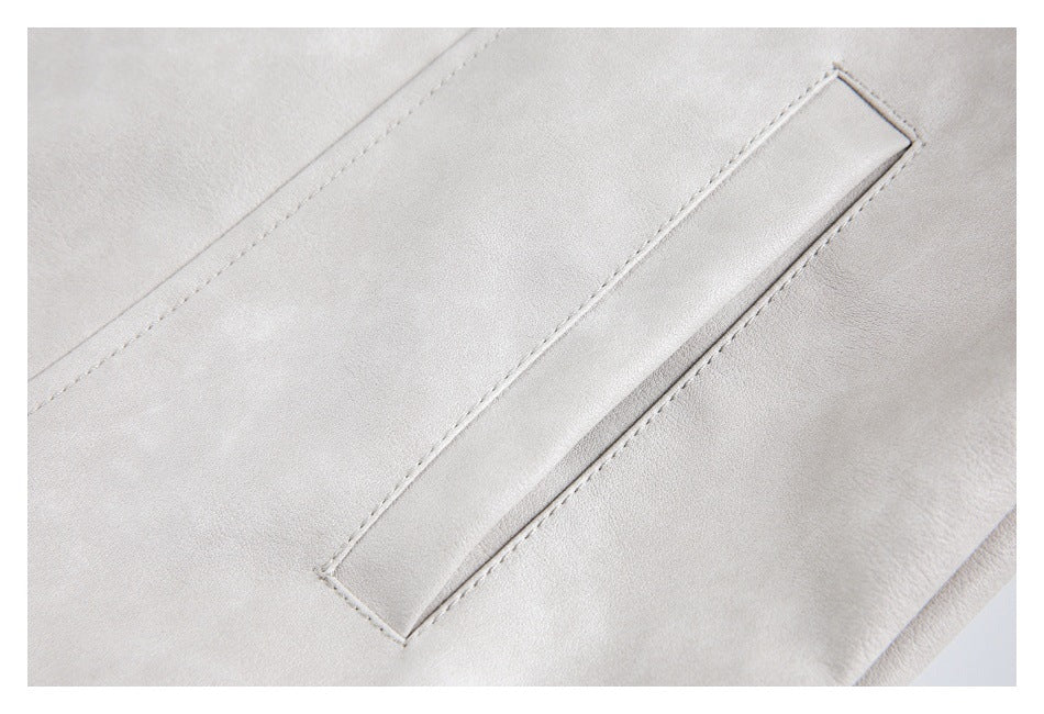 Close-up of a pale gray-beige garment with a narrow stitched welt pocket.