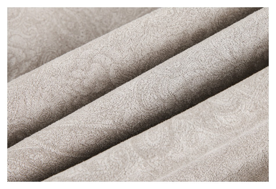 Close-up of the light taupe garment fabric showing its fine surface texture and folds.