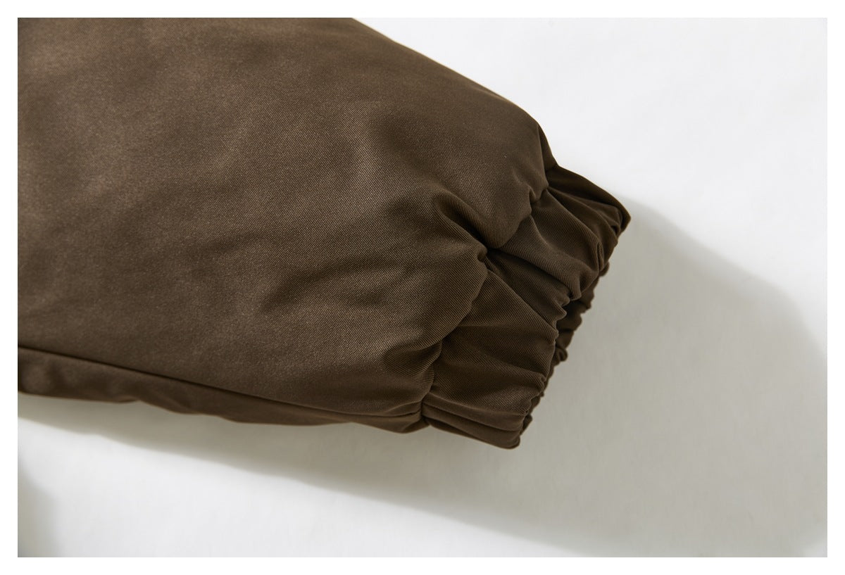 Close-up of the dark brown jacket’s gathered elastic sleeve cuff.