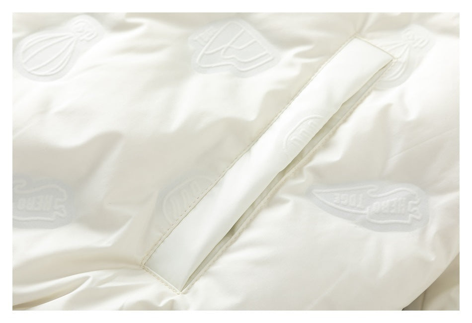 Close-up of a slanted welt pocket and subtle raised motifs on the white jacket.