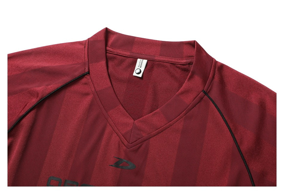 Close-up of the burgundy striped jersey's V-neck collar and black shoulder piping.