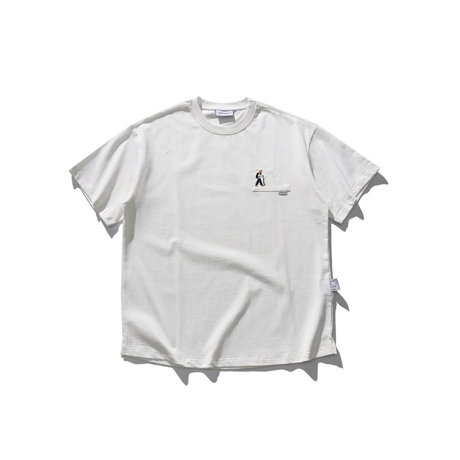White short-sleeve crew-neck T-shirt with small embroidered hiker and mountain patch on the left chest, flat lay
