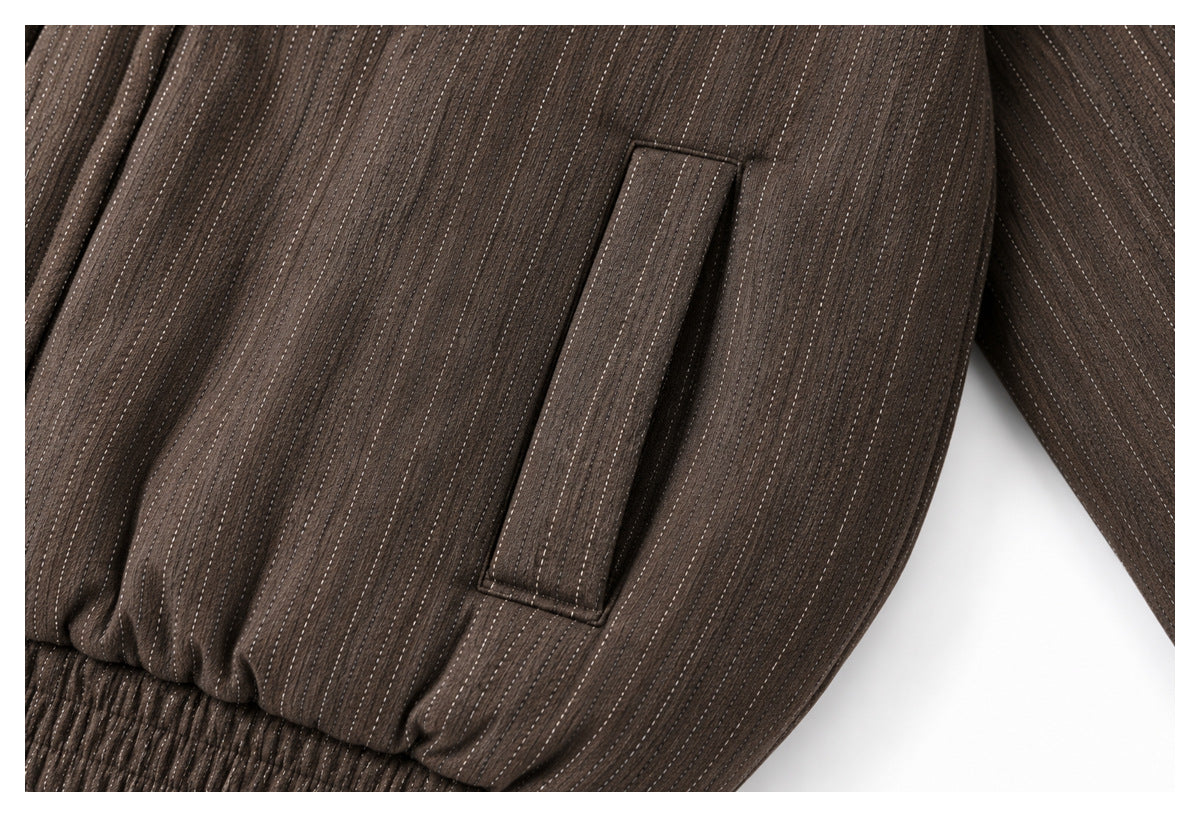 Close-up of a welt pocket and pinstripe fabric on the brown jacket.