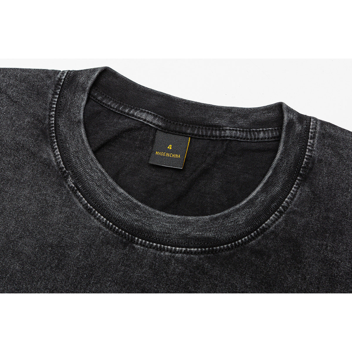 Close-up of a charcoal washed T-shirt neckline and black neck label.