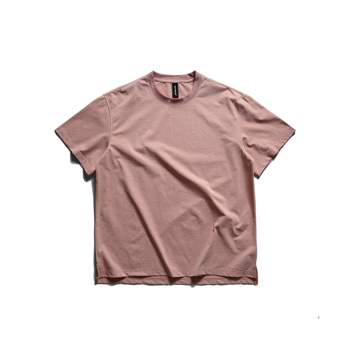 Light pink short-sleeve crew neck T-shirt laid flat, front view, with ribbed collar