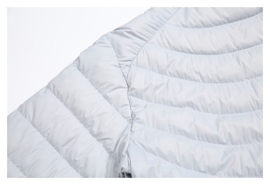 Close-up of the pale gray jacket shoulder and sleeve, showing curved quilted stitching.