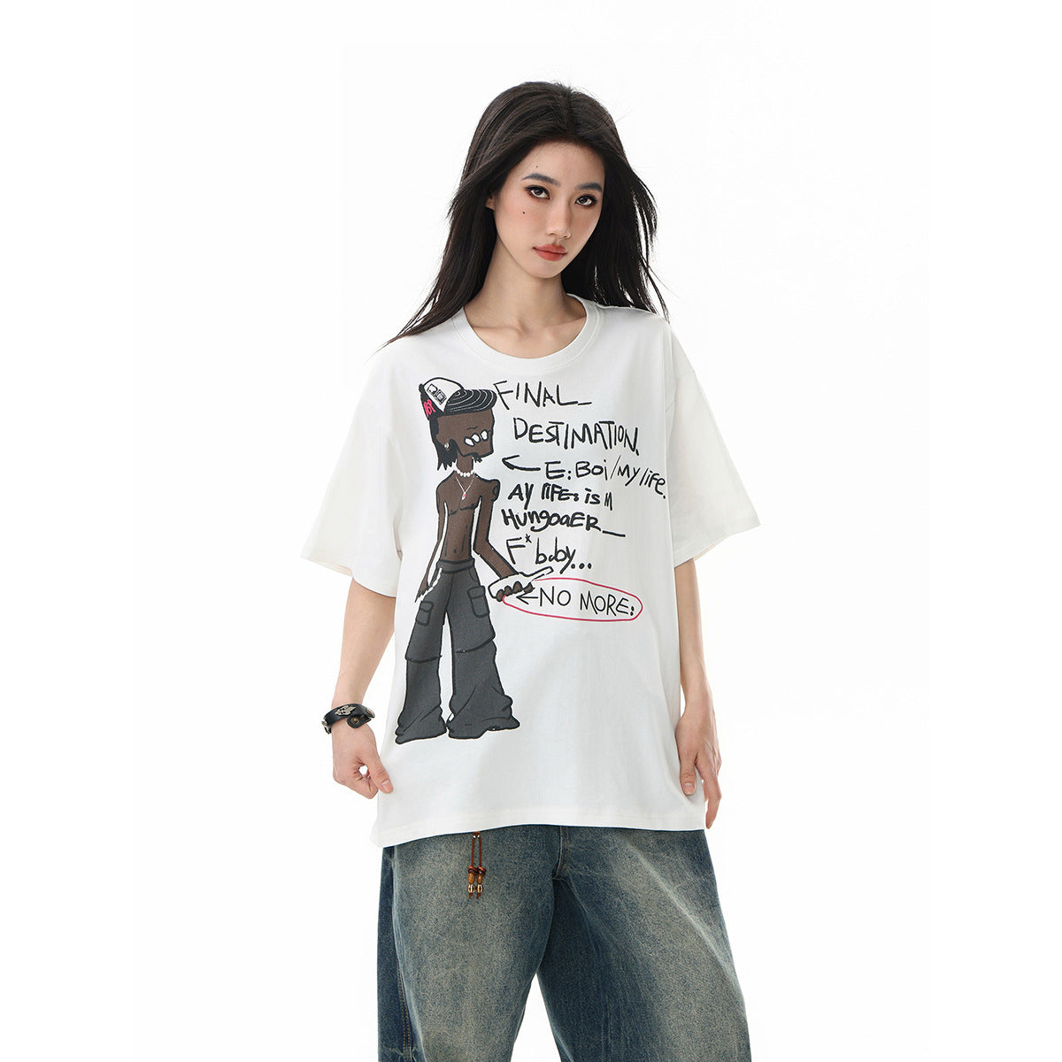 Model wearing an oversized white T-shirt with a cartoon figure and handwritten-style text on the front.