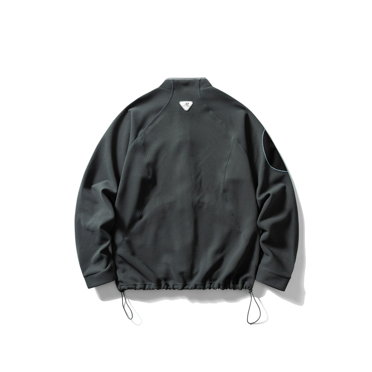 Back view of a black textured jacket with a stand collar, curved seams, a sleeve patch and adjustable hem cords.