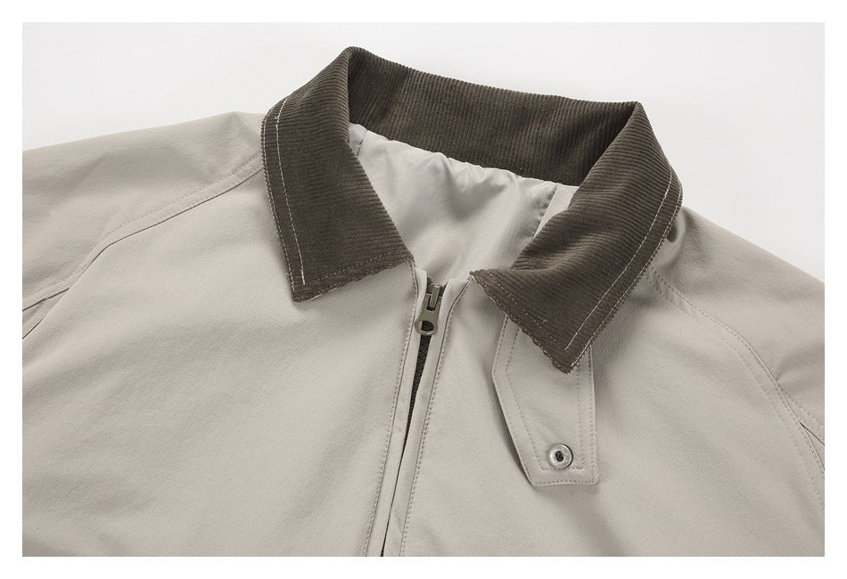Close-up of the jacket's dark ribbed collar, front zipper, and snap-button storm flap.