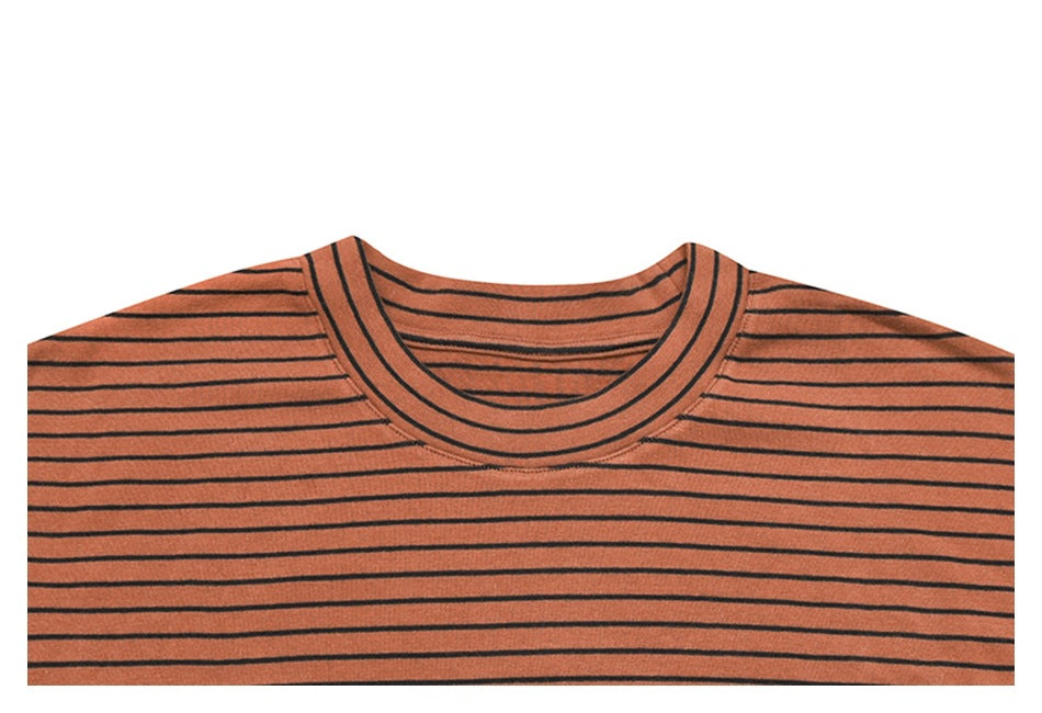Cropped front view of a rust-orange crew-neck shirt with thin black horizontal stripes.