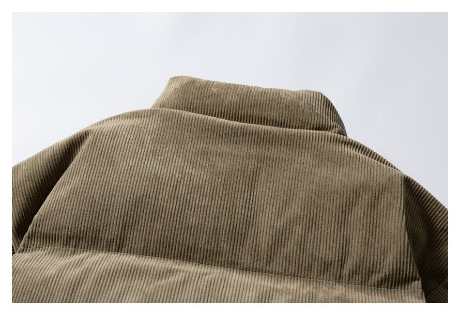 Close-up of the upper back and raised collar of a brown corduroy jacket.
