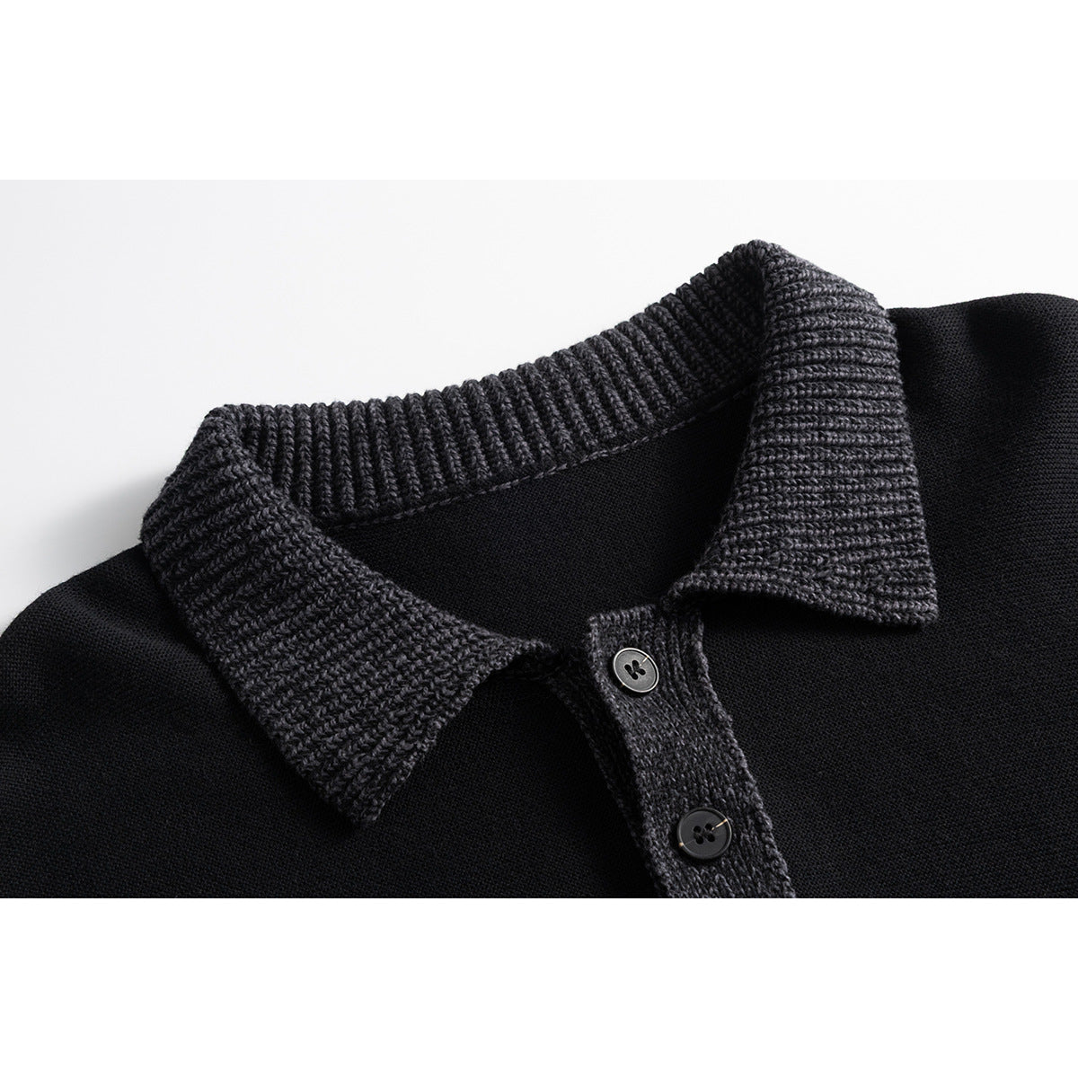 Close-up of a black sweater with a charcoal ribbed polo collar and two-button placket.