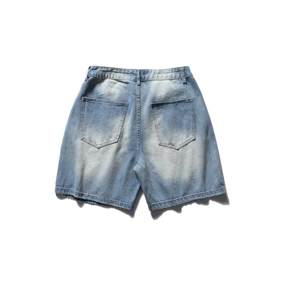 Back view of faded light blue denim shorts with two patch pockets and finished hems.