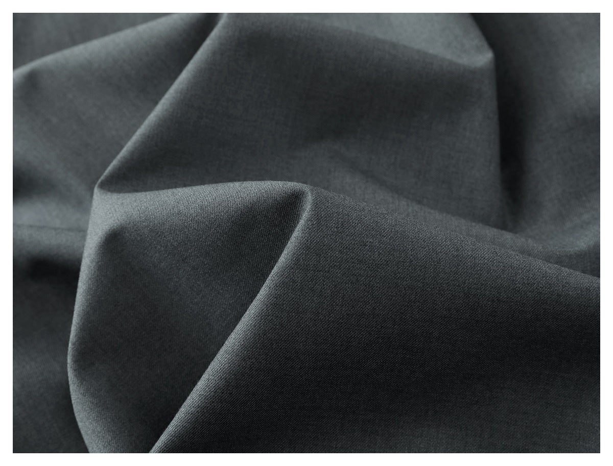 Close-up of charcoal-gray fabric draped into folds, showing its surface texture.