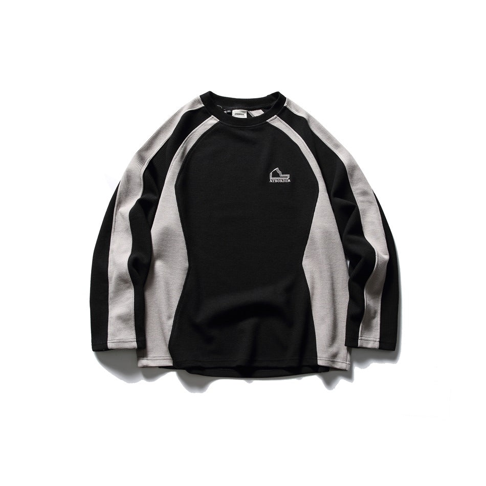 Black crew-neck sweatshirt with light gray raglan sleeve and side panels and a small embroidered chest logo
