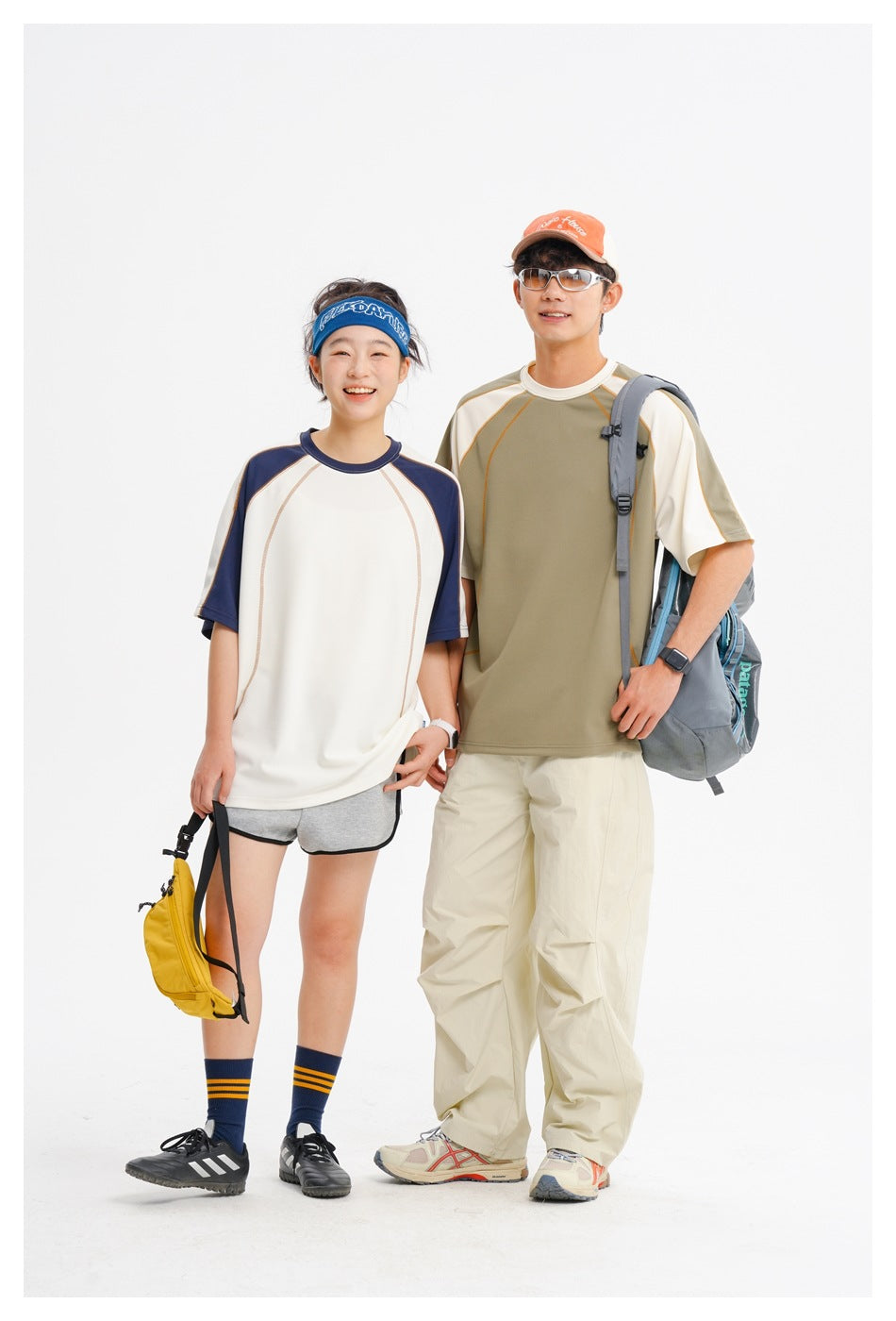 Two models wear short-sleeve raglan shirts: one ivory with navy sleeves, the other olive with ivory sleeves.
