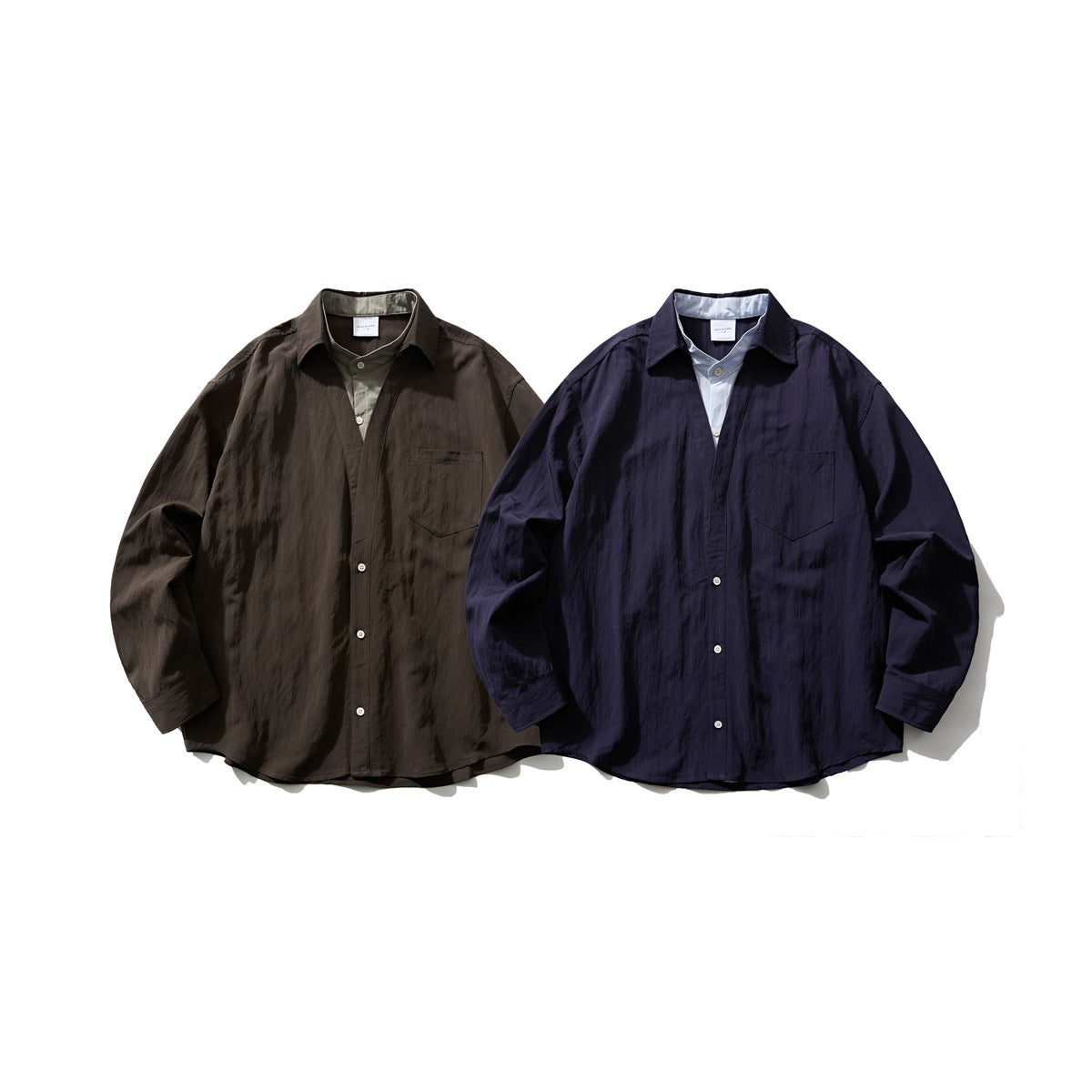 Two long-sleeve button-up shirts shown from the front in dark brown and navy, each with a chest pocket.