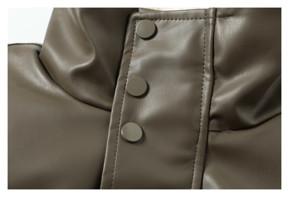 Close-up of three matching round snap buttons on the olive-gray jacket's front placket.