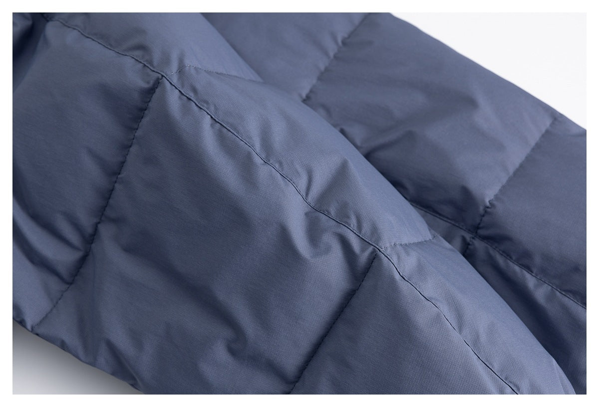 Close-up of the blue-gray jacket's padded, stitched body panels.