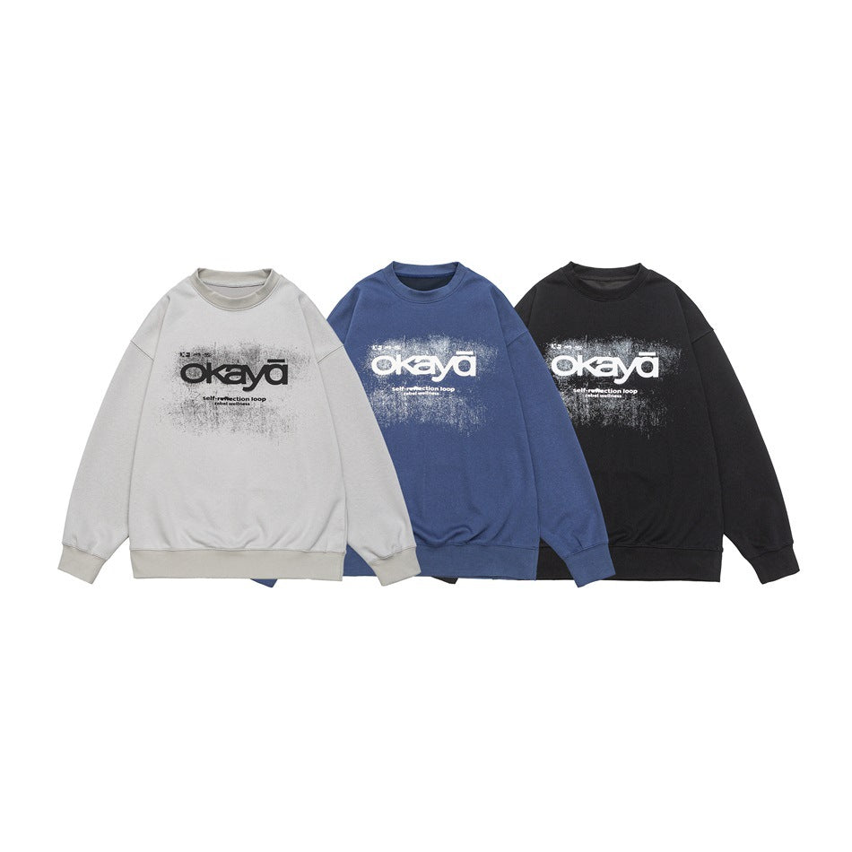 Three crewneck sweatshirts displayed together in light gray, blue, and black, each with a distressed chest graphic.