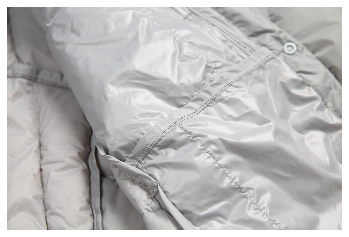 Close-up of the light gray jacket lining, showing stitched seams and a snap fastener.