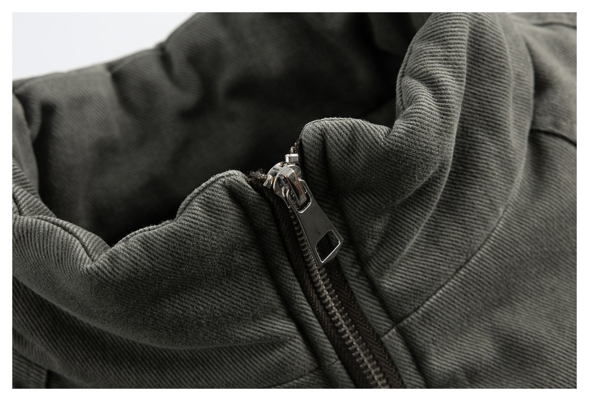 Close-up of the charcoal gray jacket's raised collar and silver front zipper pull.