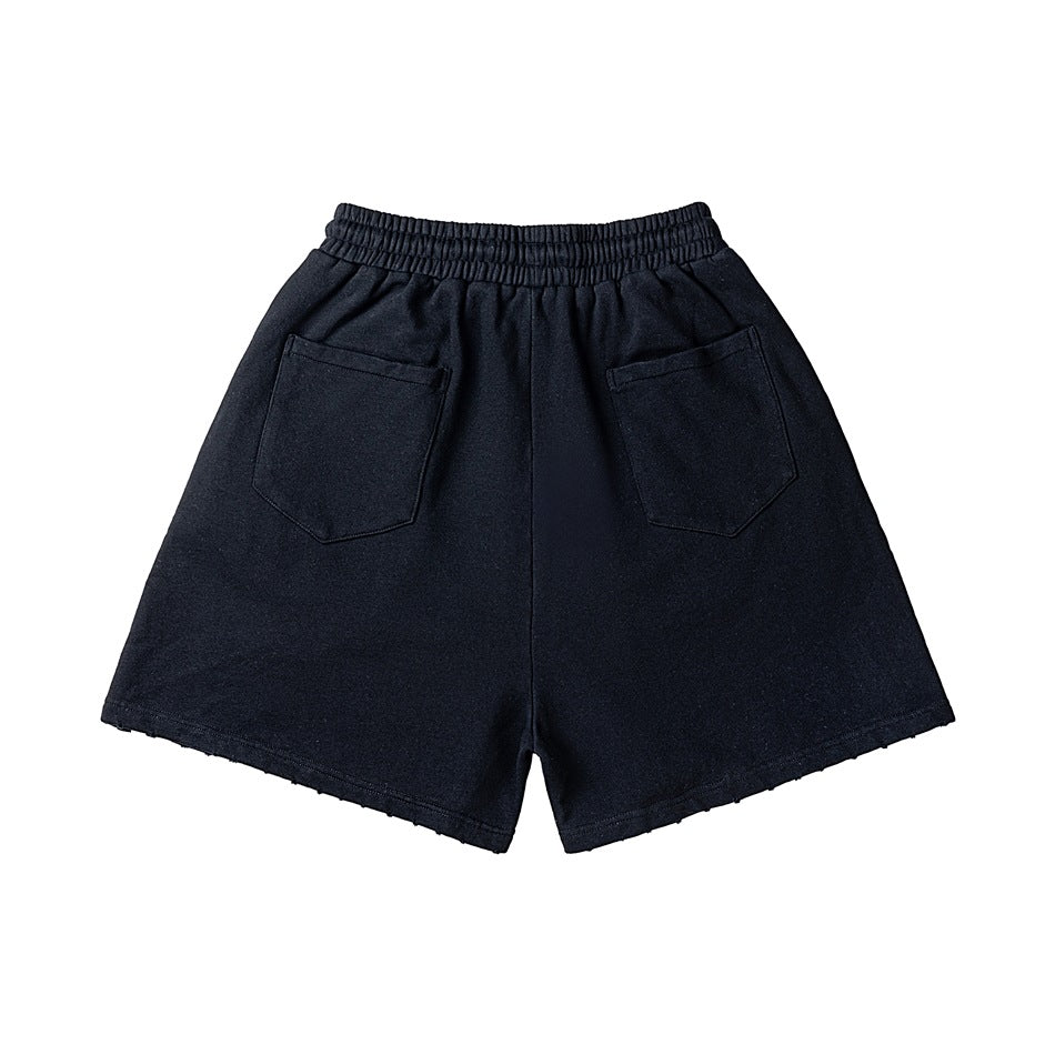 Back view of black elastic-waist shorts with two patch pockets and frayed hem edges, flat lay
