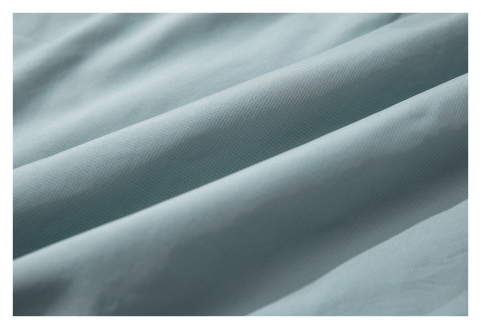 Close-up showing the fine grid texture of pale blue-gray garment fabric.