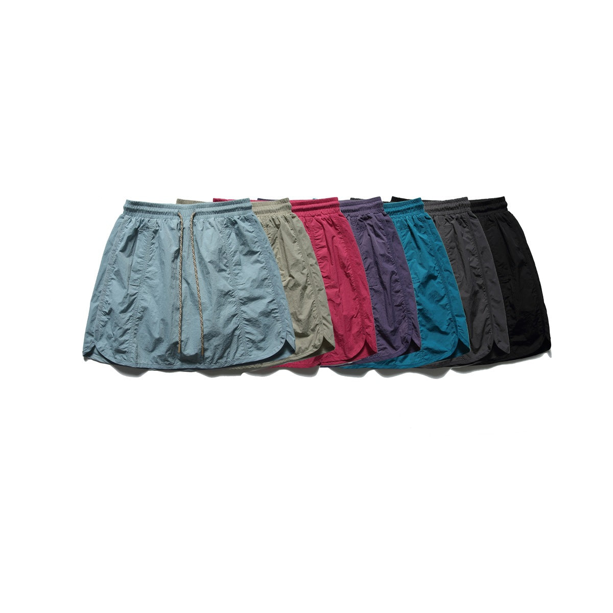 Several pull-on skirts displayed together in blue-gray, taupe, pink, purple, teal, charcoal, and black.