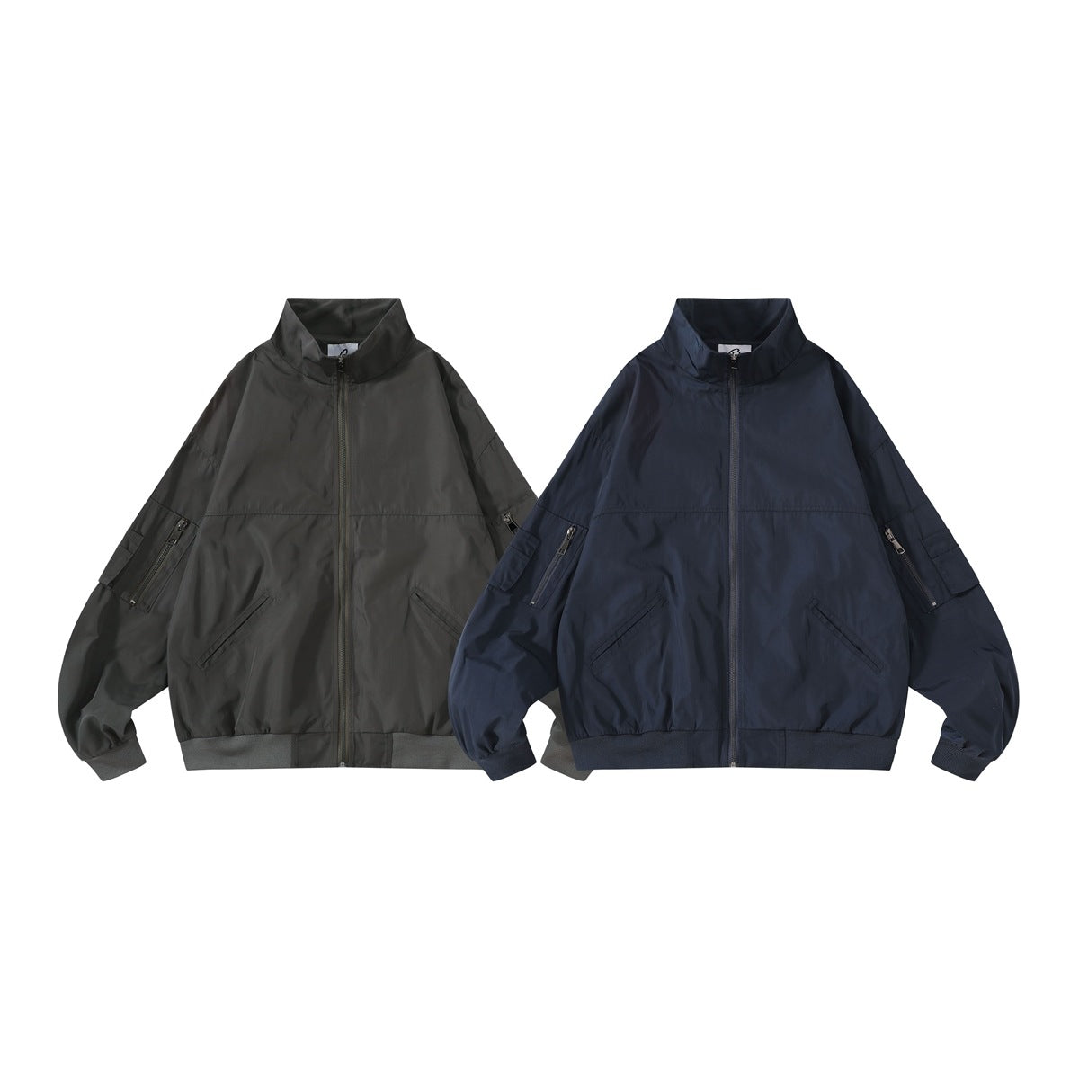 Two zip-up stand-collar jackets side by side, one dark charcoal-black and one navy blue, flat front view