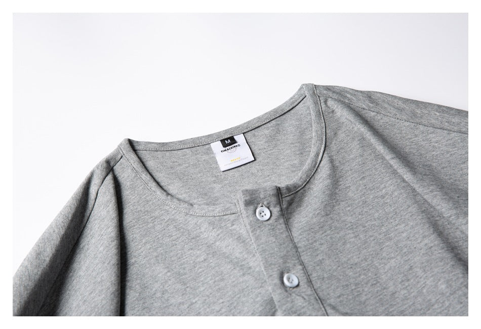 Close-up of the heather gray shirt's round neckline, neck label, and two-button front placket.